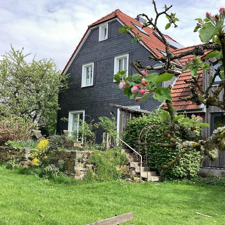 a black house with a red roof at Hahnhaus in Burscheid