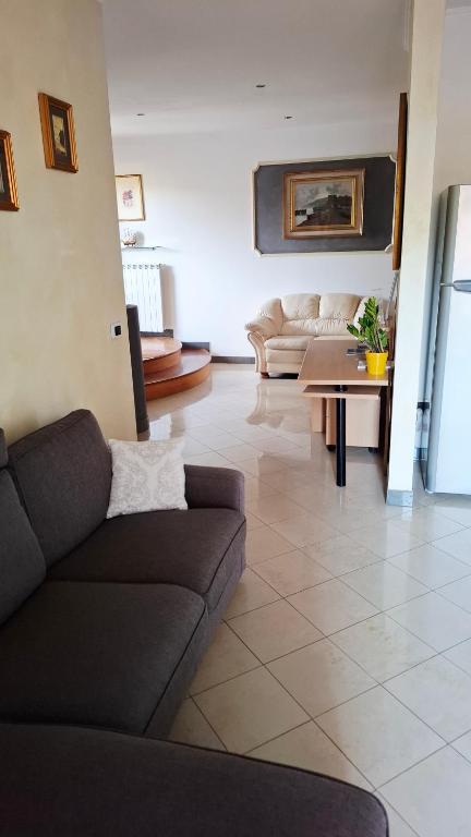 a living room with a couch and a table at The Happy Goat Apartment in Germignaga