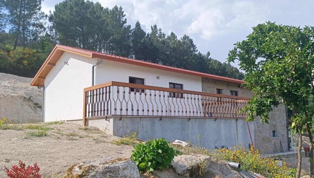a house with a balcony on the side of it at Casa do Maninho in Amarante