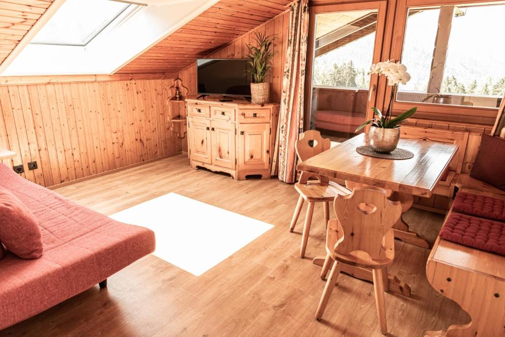 a living room with a table and a couch at Haus Lohengrin Ferienwohnung 5 in Siusi