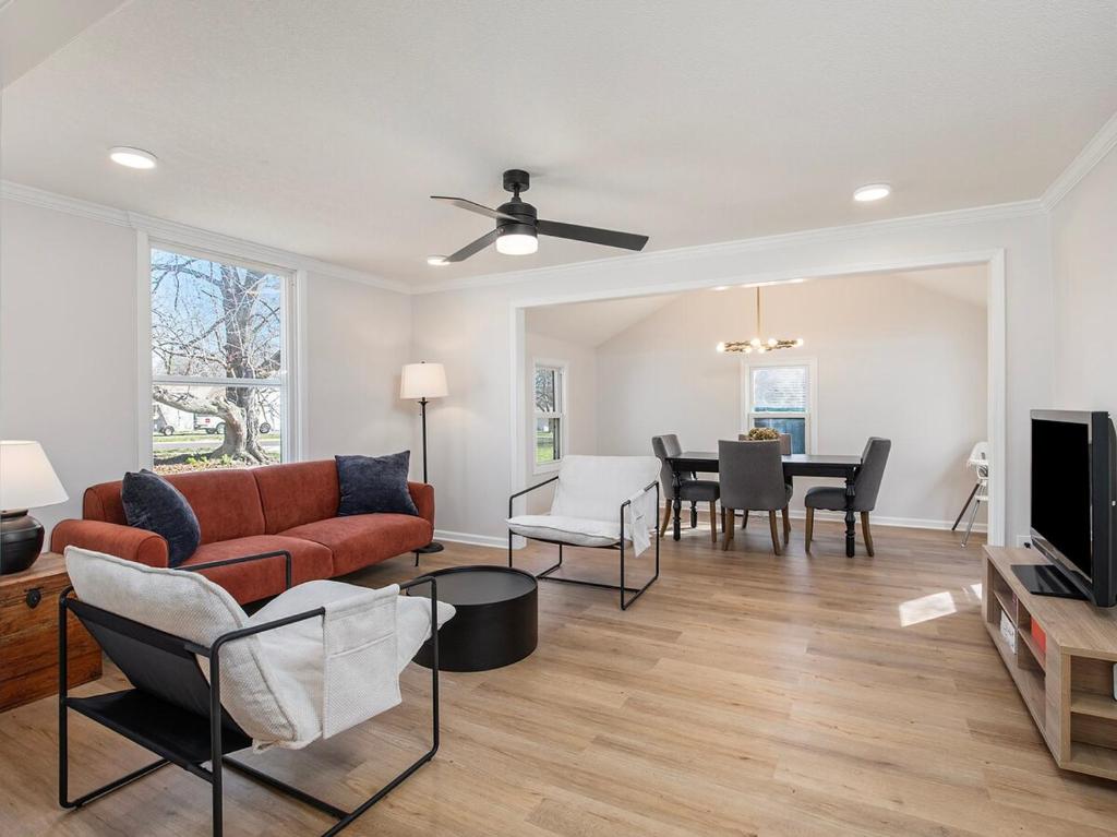 a living room with a couch and a table at Charming 3BD 2BR Dog Friendly in Overland Park