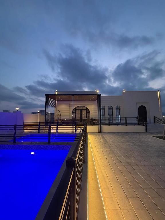 a swimming pool on the roof of a building at رزات كاسا - للعائلات فقط in Gharnūt