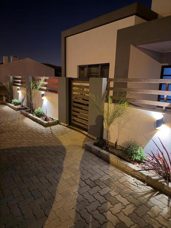 a house with a stone driveway in front of it at Oregano Estate in Swakopmund