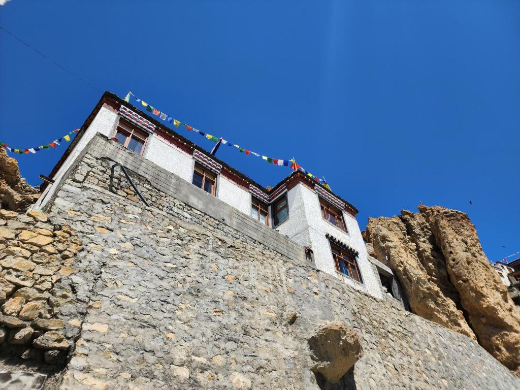 a building on the side of a mountain at Mochilero Eyrie in Kaza