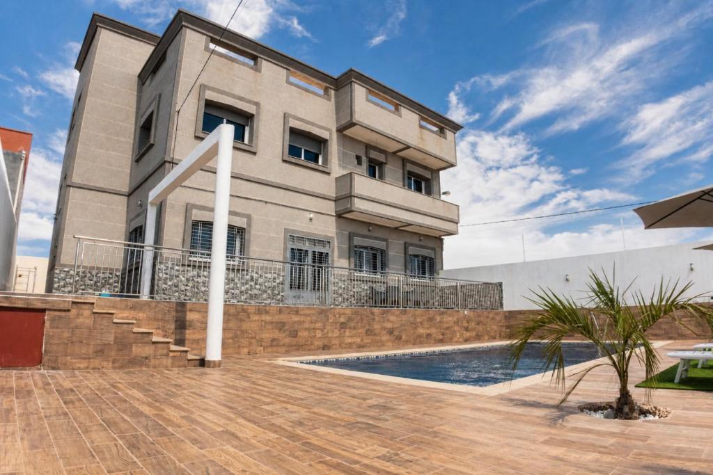 a house with a swimming pool in front of it at Villa Raha in Selouane