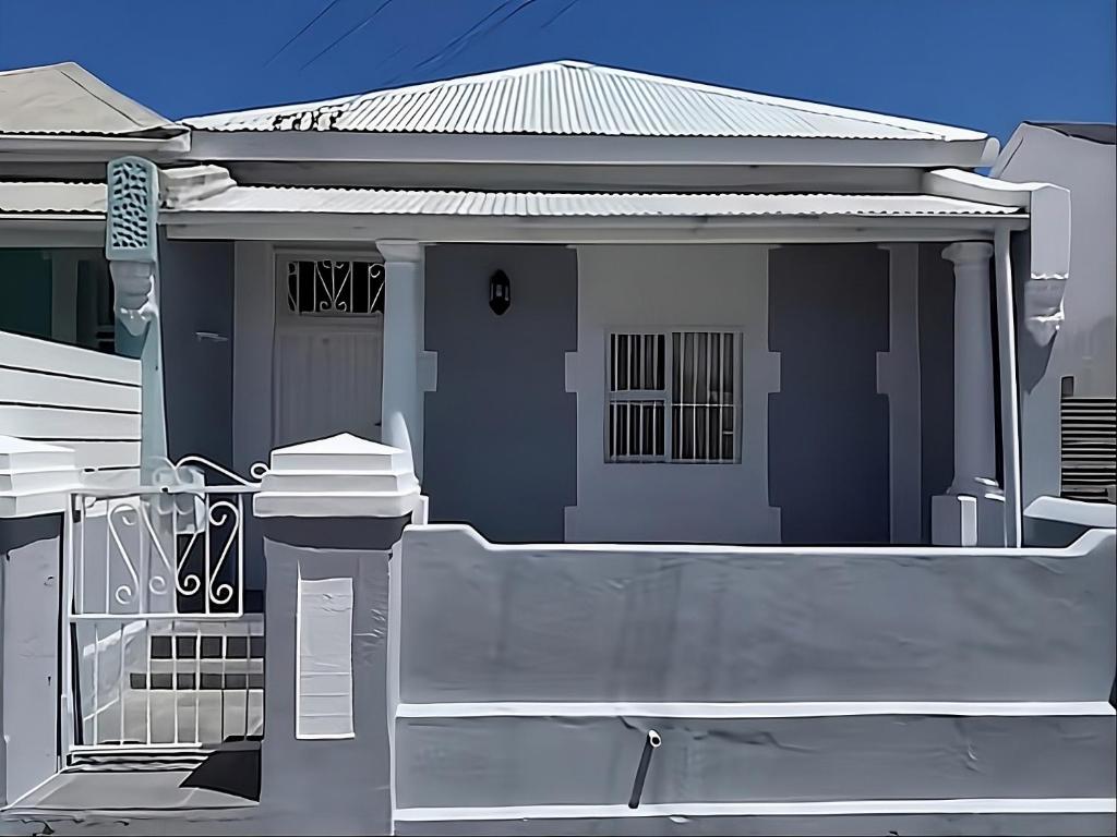 a house with a fence in front of it at Evangeline House in Cape Town