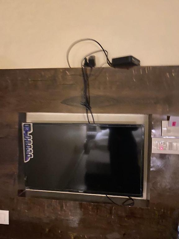 a microwave with a charger on top of it at FabHotel BD Colaba in Mumbai