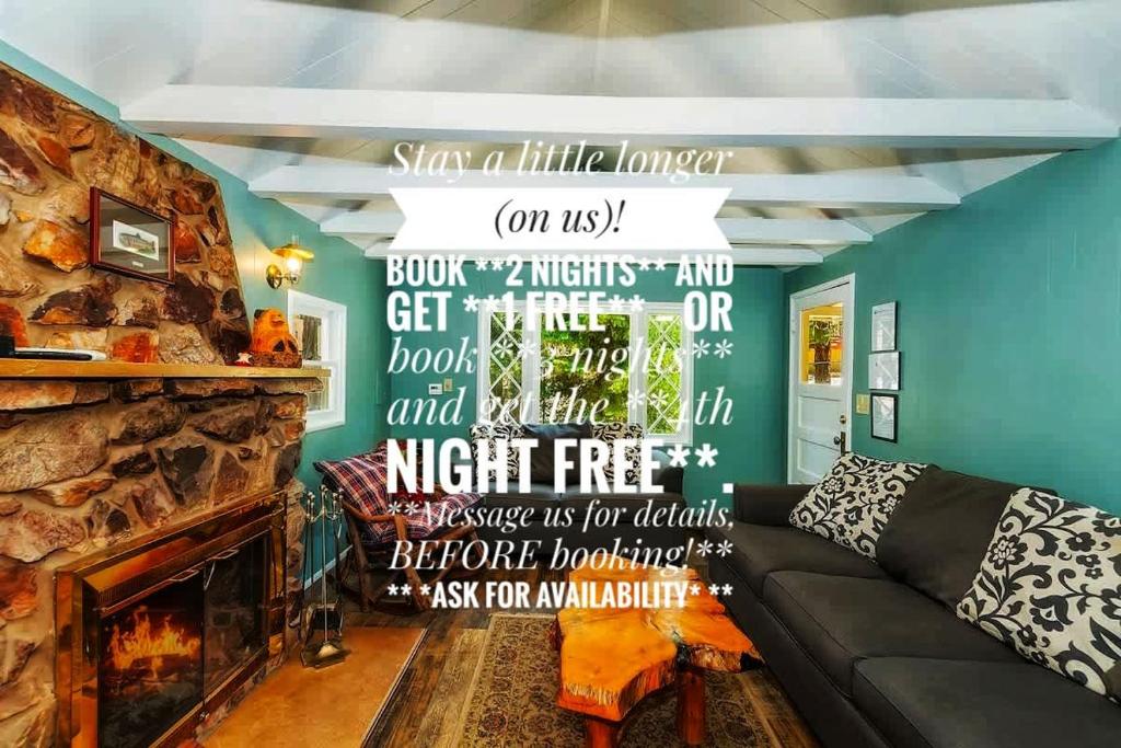 a living room with a couch and a fireplace at Applewood Cabins & Guest Cabin Near the Village in Big Bear Lake