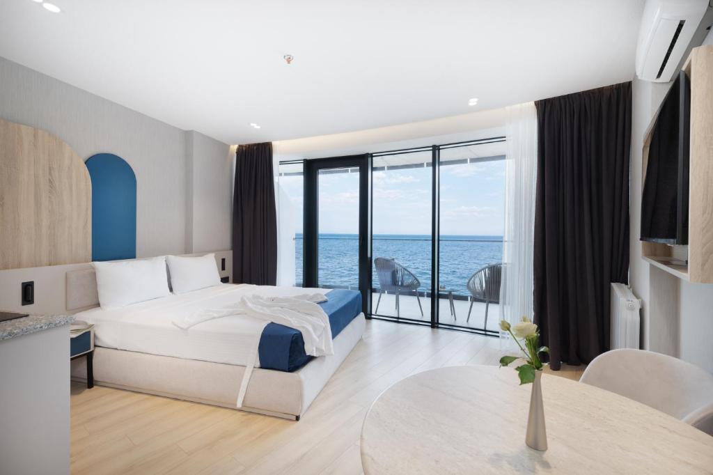 a bedroom with a bed and a view of the ocean at Marina Club in Batumi