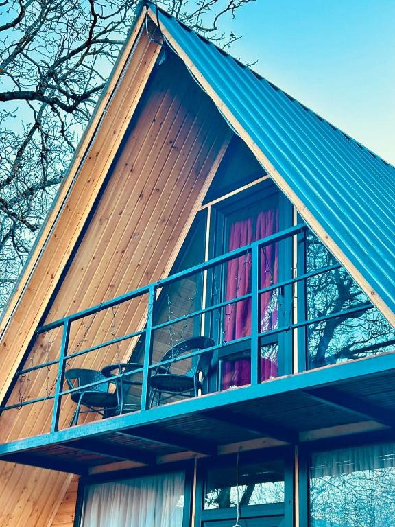 a house with a large window on top of it at Sisters House in Borjomi