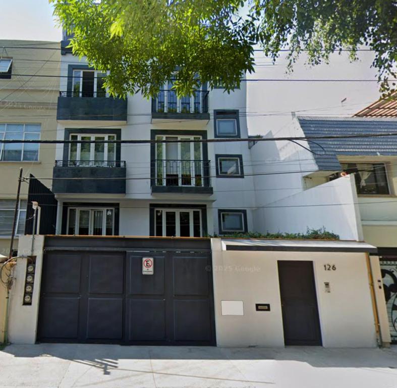 a building with two garage doors and a building at MRE Goldsmith Polanco in Mexico City