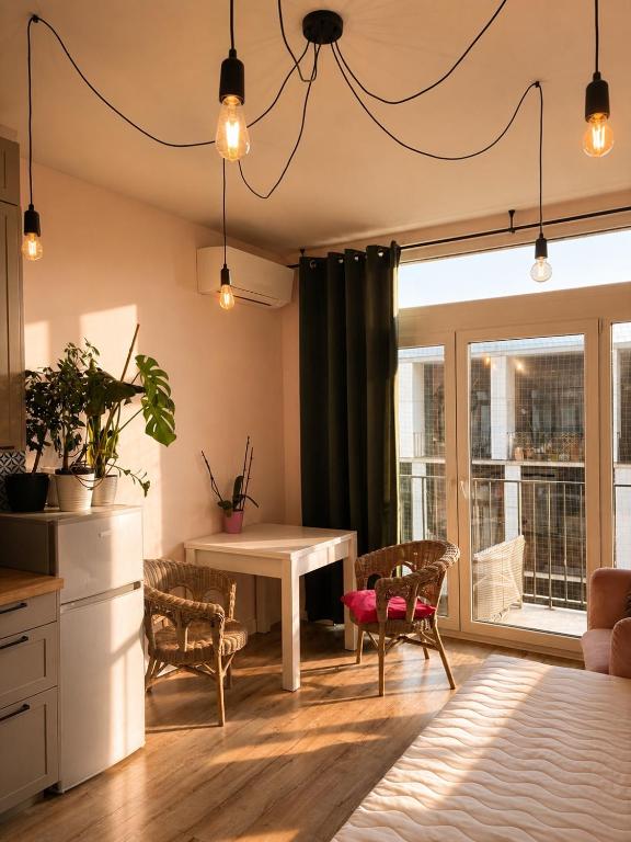 a kitchen and dining room with a table and chairs at MIŁO Apartament Zarembowicza in Wrocław