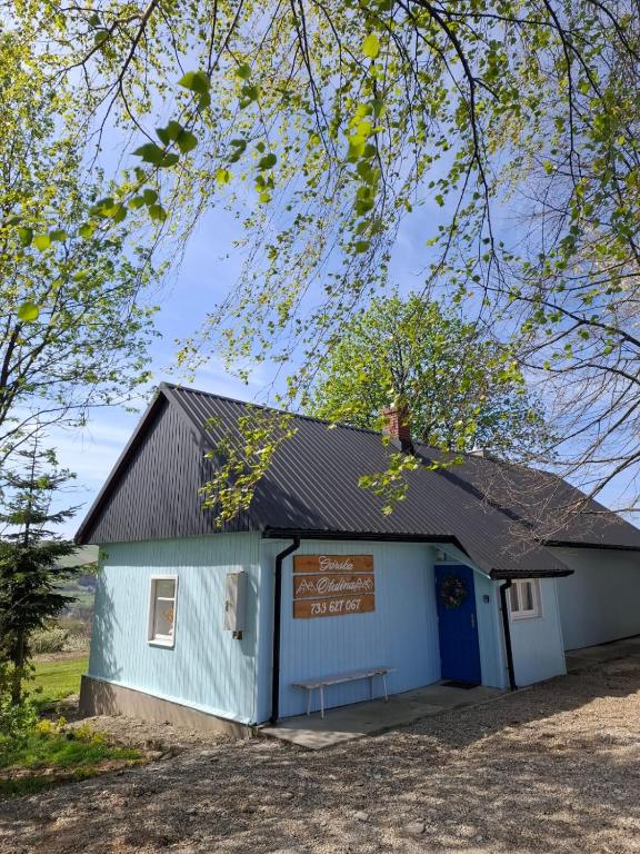 a blue and white building with a sign on it at Górska Otulina in Wilkowisko