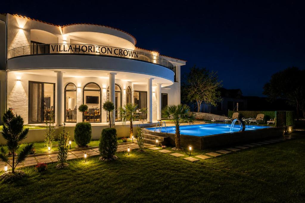 a house with a swimming pool in the yard at night at Horizon Crown Rooms Ulcinj in Briska Gora