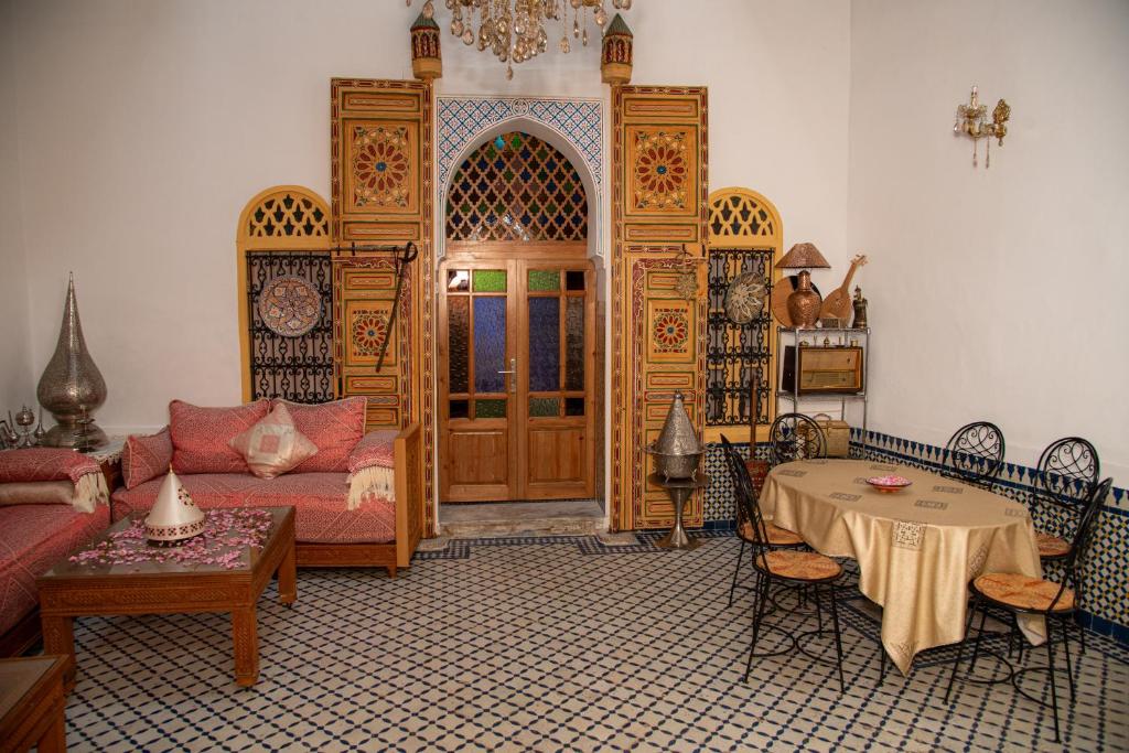 a living room with a couch and a table at Riad Rita in Meknès