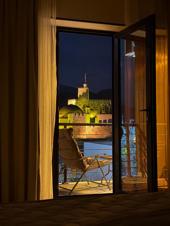 a room with a window with a view of a castle at Hotel DIAMOND - სასტუმრო დაიმონდ in Akhaltsikhe