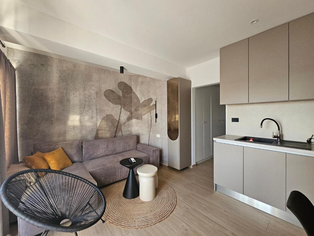 a living room with a couch and a kitchen at Brand New seaside Apartments NOA & JAKOV, Zaboric Sibenik in Zaboric