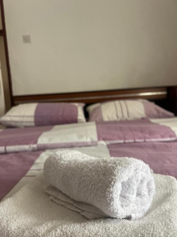 a white towel sitting on top of a bed at Stan Uljarević in Zlatište
