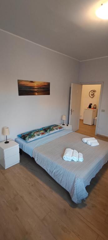 a bedroom with a large bed with two towels on it at Modena Private Room in Modena