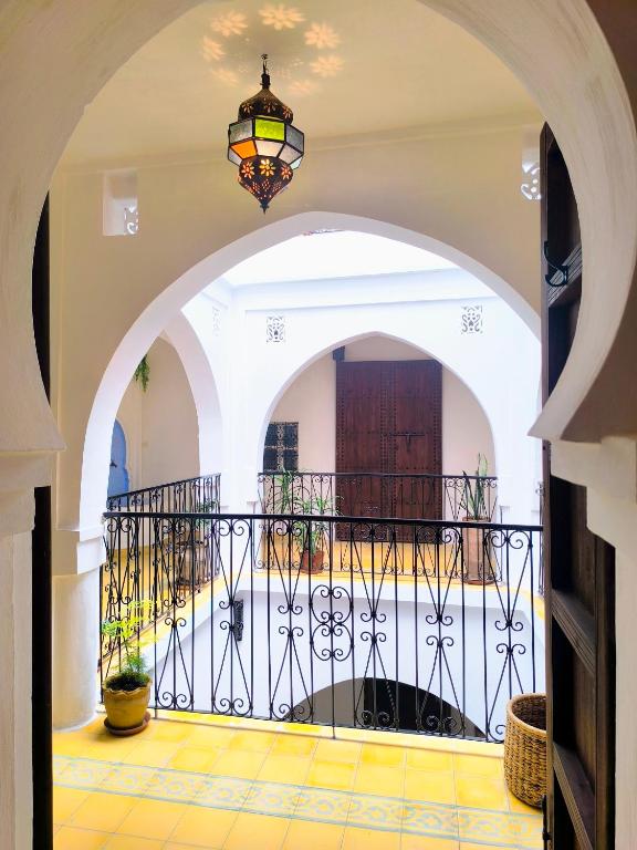 an archway with a gate and a balcony at Riad Louisa in Chefchaouen