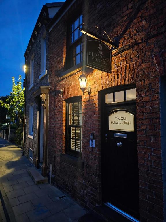 a brick building with a sign above a door at 1 Bed Cottage Great Ayton - TOP Cottage in Great Ayton