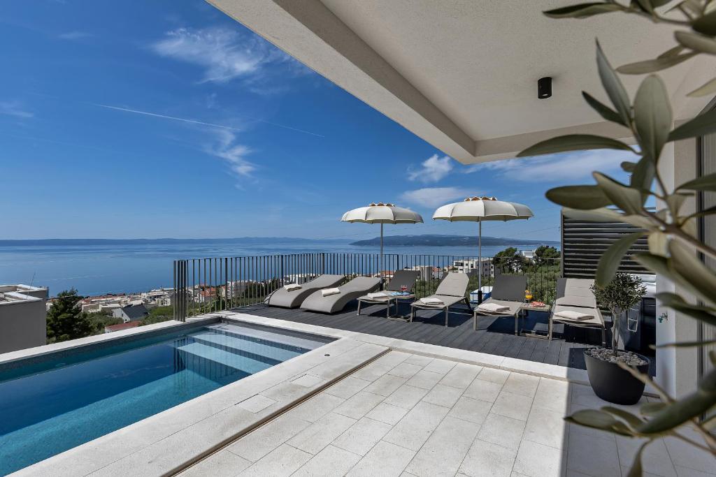 a swimming pool with a view of the ocean at Villa Reina in Makarska