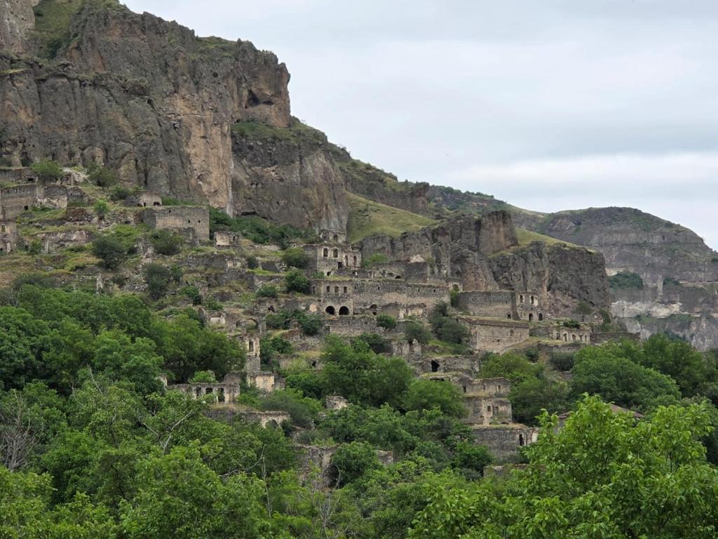 a mountain with dwellings on the side of it at Кирч Горис in Goris