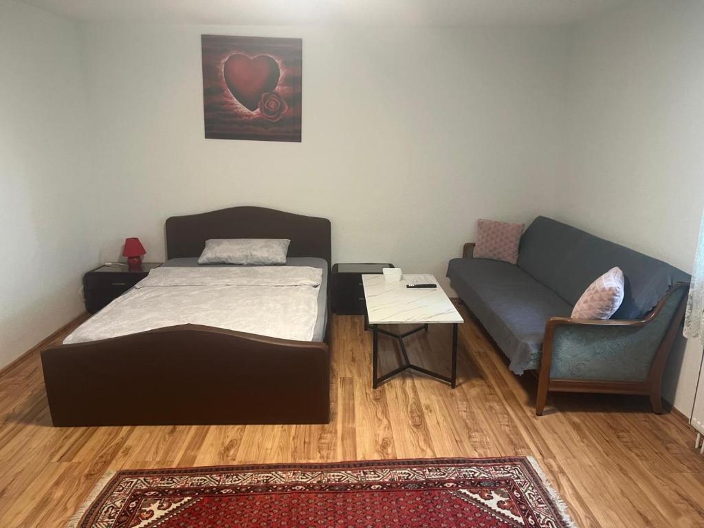 a small room with a bed and a couch at LUNA in Bad Säckingen