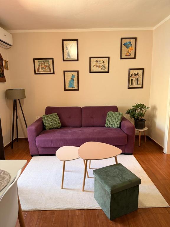 a living room with a purple couch and a table at Mivasto Sea View in Risan