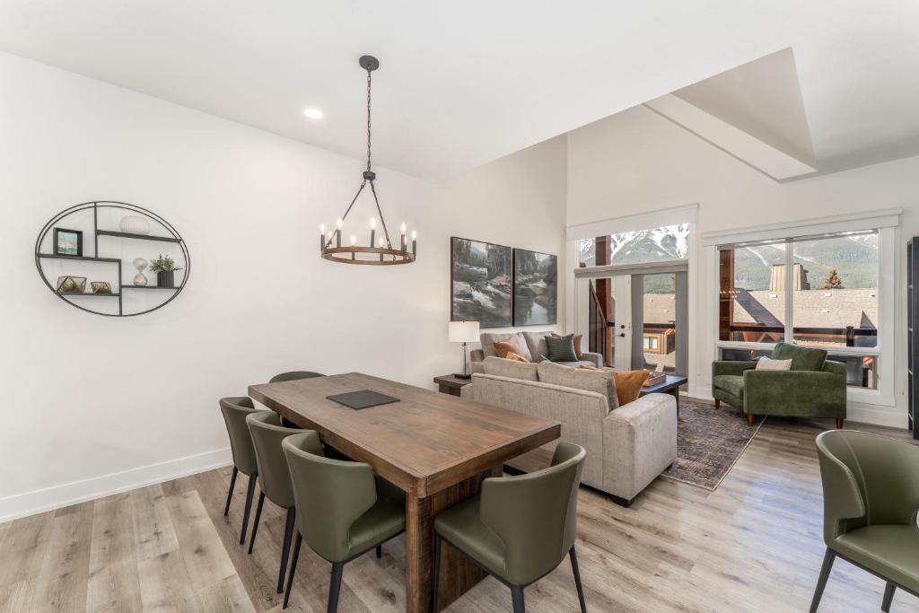 a dining room and living room with a table and chairs at Spectacular Penthouse With Amazing Views, Indoor Pool and Hot tub in Canmore