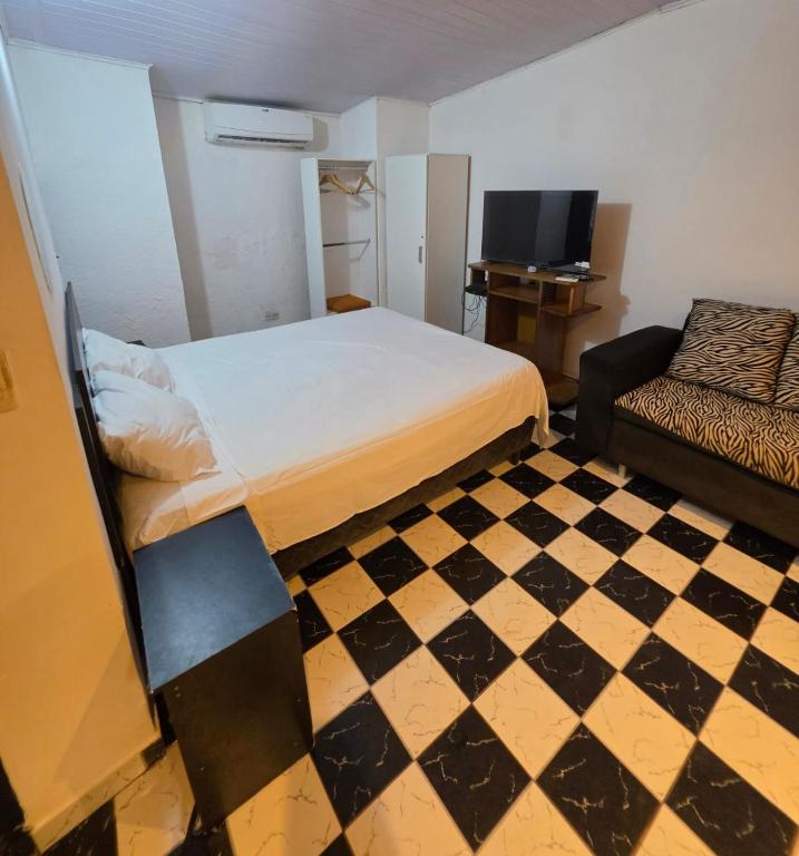 a bedroom with a bed and a checkered floor at Ypane Residencial in Ypane