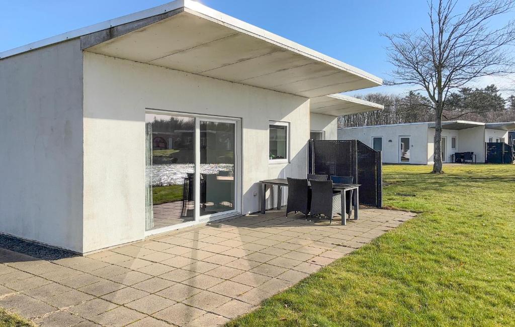 a white house with a table in front of it at Stunning Home In Ringkøbing With Wifi in Ringkøbing