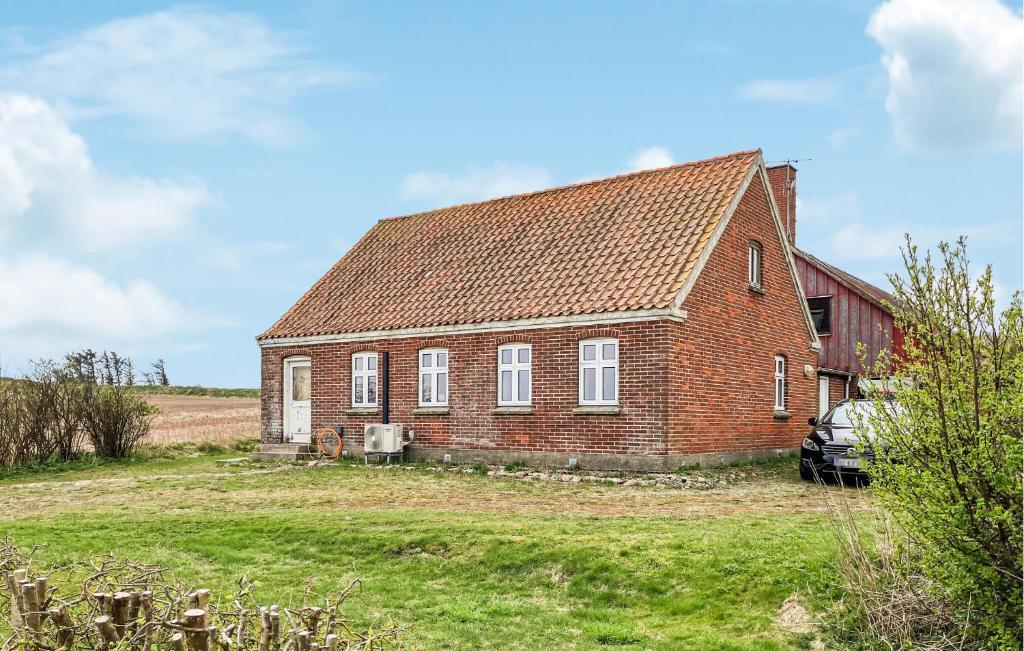 an old brick house with a red barn at 3 Bedroom Stunning Home In Bedsted Thy in Bedsted Thy