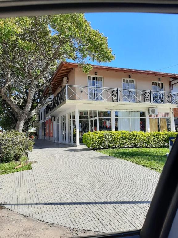 a building with a walkway in front of it at Del Centro Dptos in Federación
