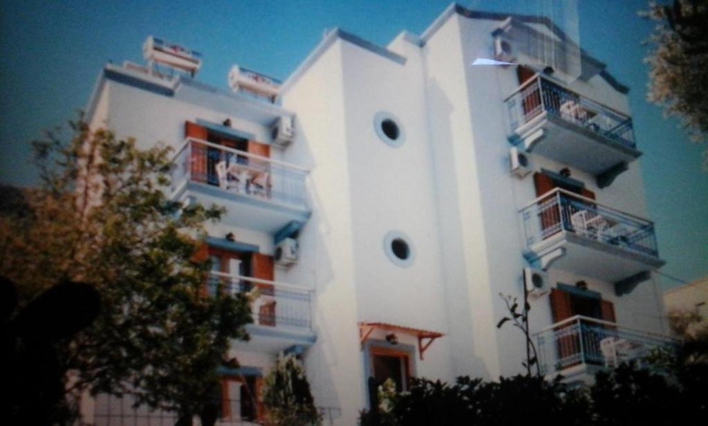 a large white building with balconies on it at Panorama Studios in Meyisti