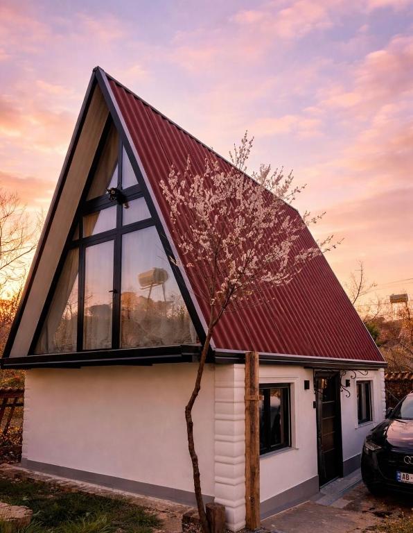 a small white house with a red roof at Happy Stayy in Patza-Kuqani