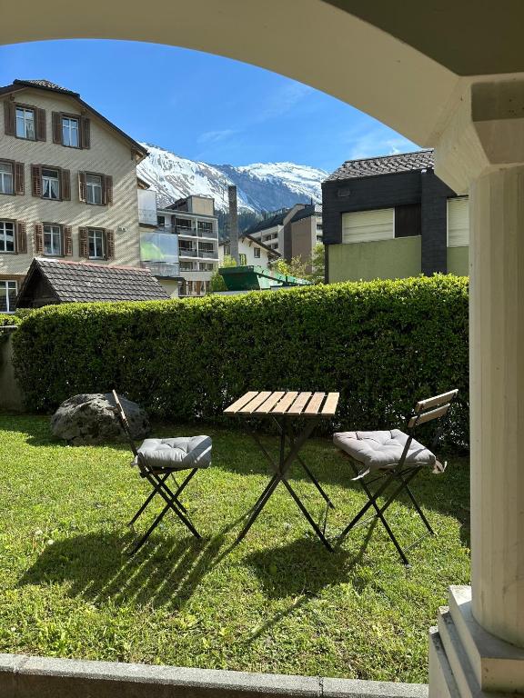 two chairs and a picnic table in the grass at Alpine Nest Tiltlis, Garden, Central, Lucerne in Engelberg