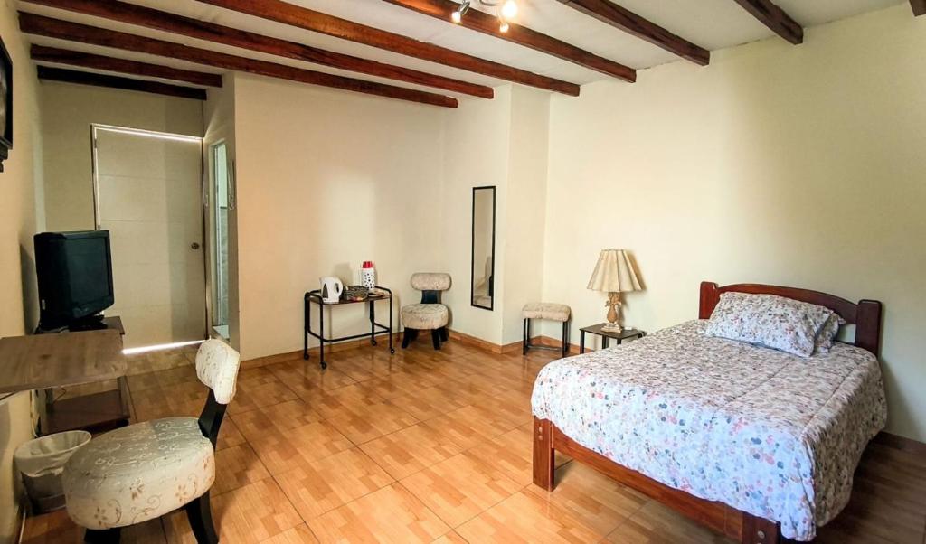 a bedroom with a bed and a tv in it at ENHEBRA HOUSE in Lima