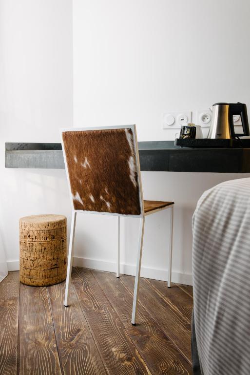 a wooden chair in a kitchen with a counter at Atypik Hotel in Clichy