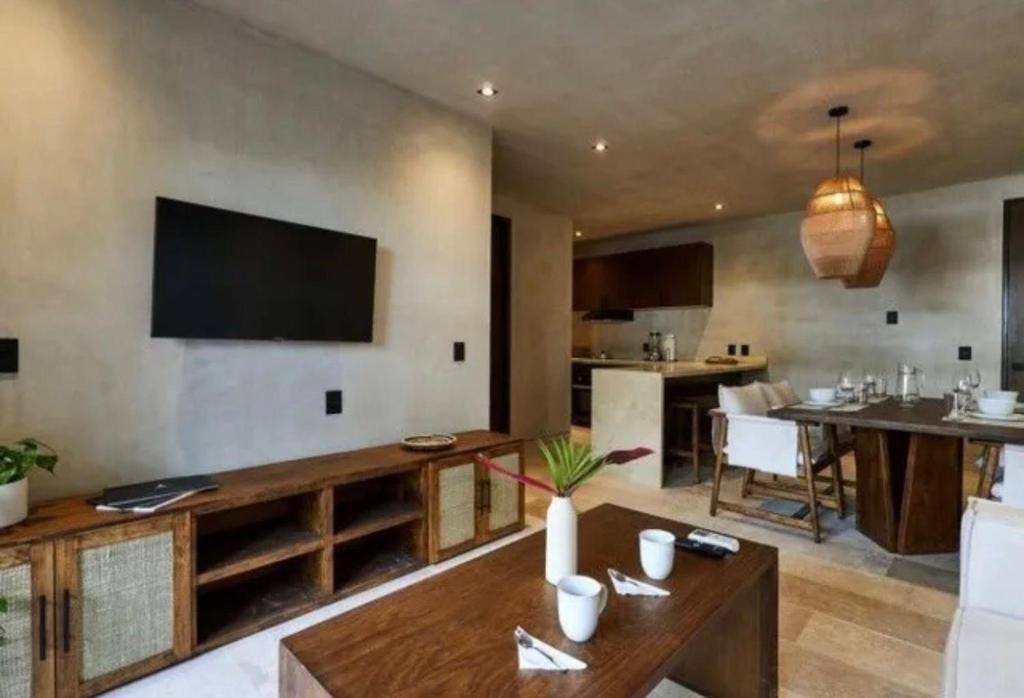 a living room with a television on the wall at Bakal Luxury Condos in Tulum