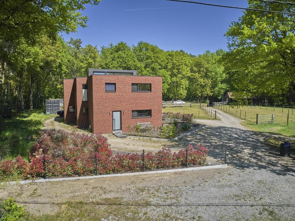 a brick house in the middle of a garden at Huus 16 in Zutendaal