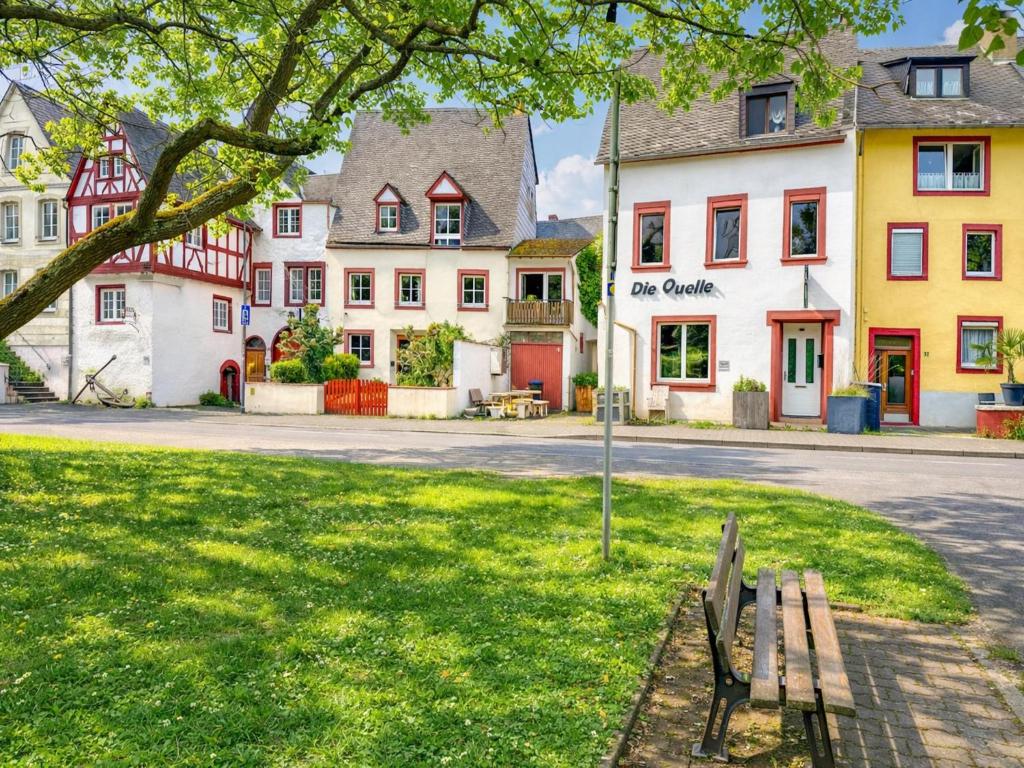 a park with a bench in front of a street at Quelle in Bernkastel-Kues