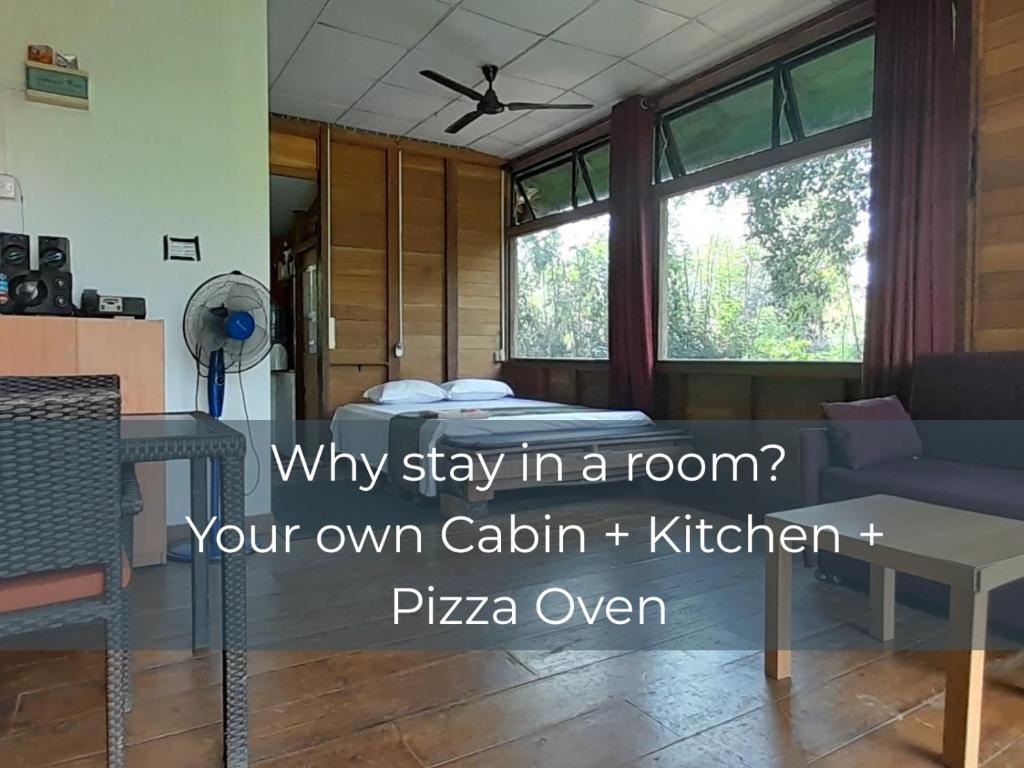 a living room with a couch and a table at Private Cabin and private Kitchen - Experience serenity, and beautiful nature in Sigiriya