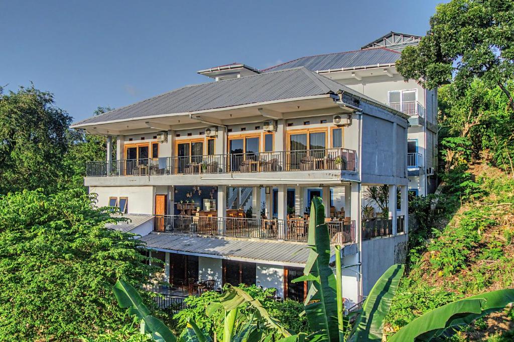 a large house on top of a hill at Hotel Bonne Nuit in Labuan Bajo