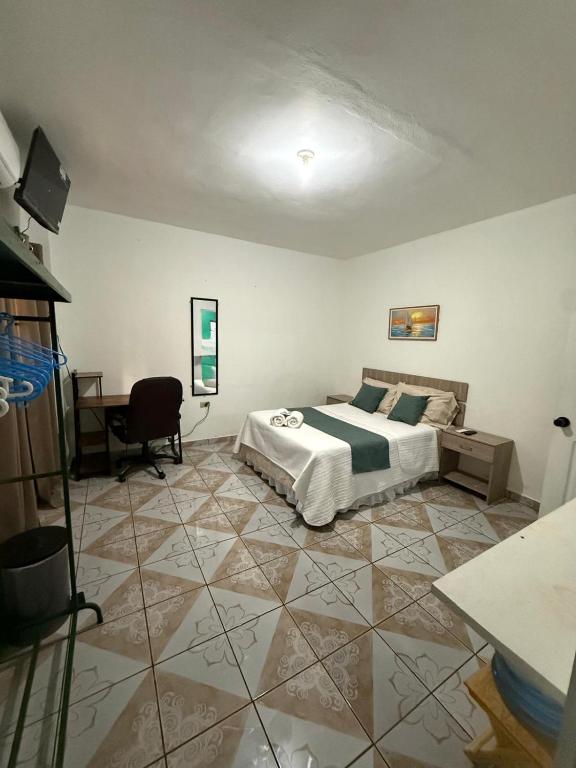 a bedroom with a bed and a desk in it at Tunco SurfHouse in El Sunzal