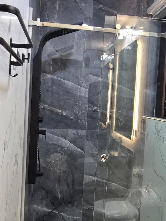 a shower with a glass door in a bathroom at RoofTop8 in Cochabamba