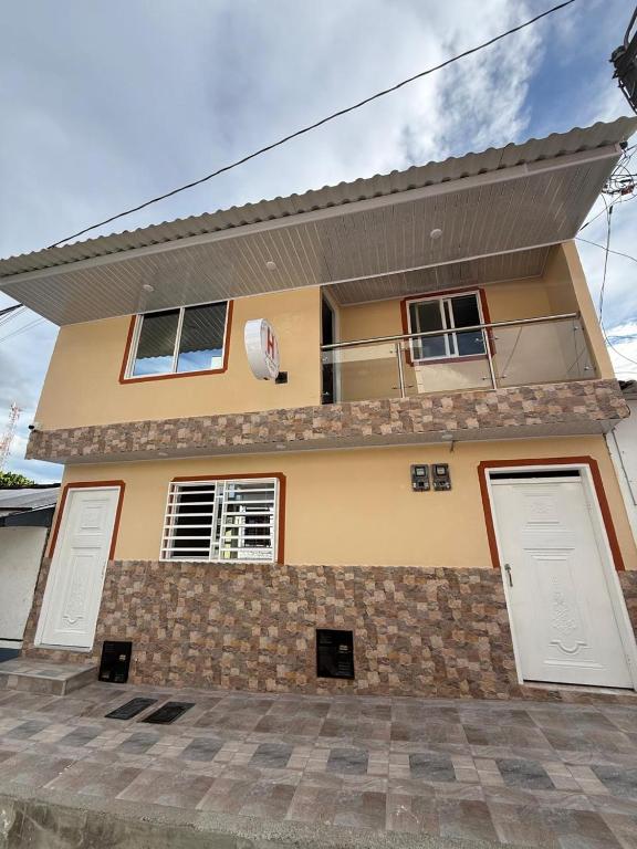 a house with two garage doors in front of it at Hostal Ruta Cafetera in La Tebaida