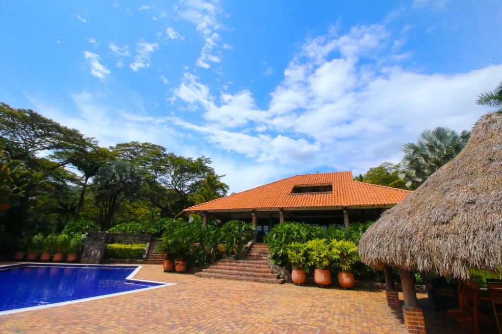 Casa con piscina y techo de paja en Casa Santa María, en Restrepo