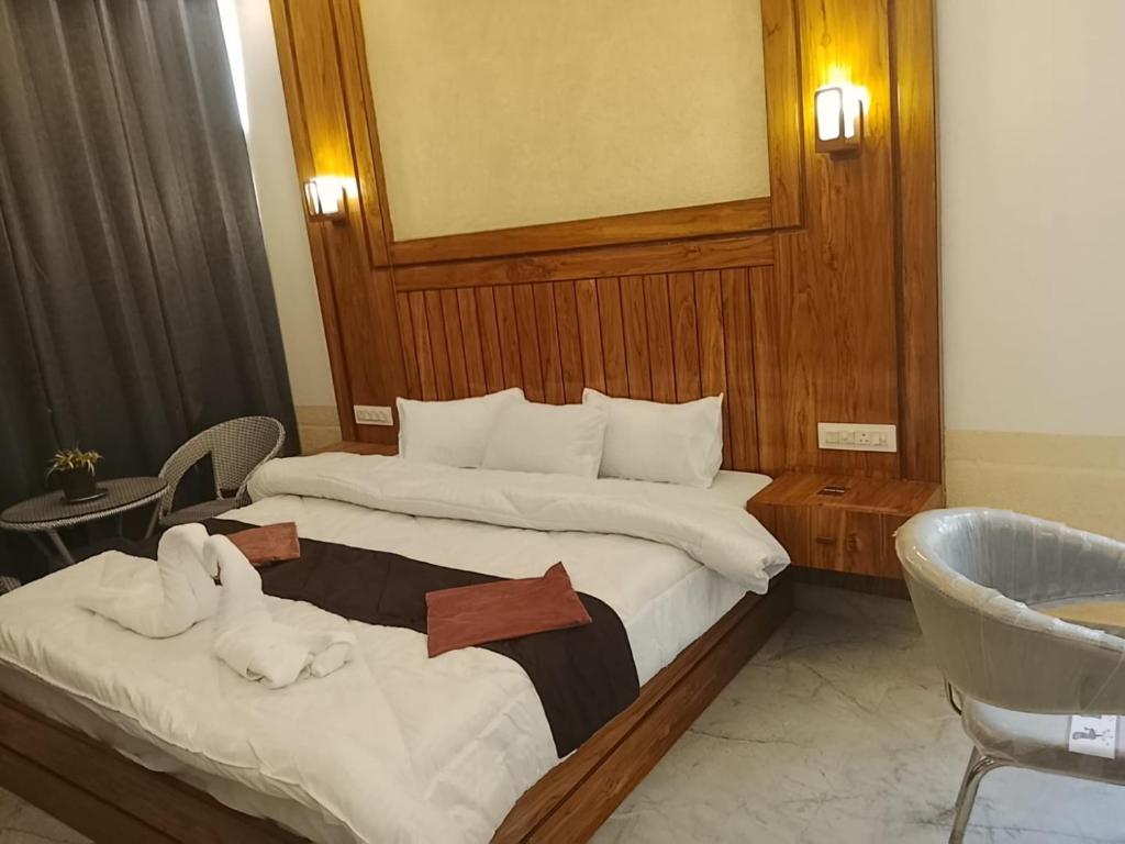 a hotel room with two beds with towels on them at Pahadi Basera Kasauli in Kasauli