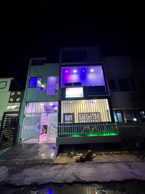 a building with a dog laying in front of it at night at Mitanvi the heaven in Ujjain